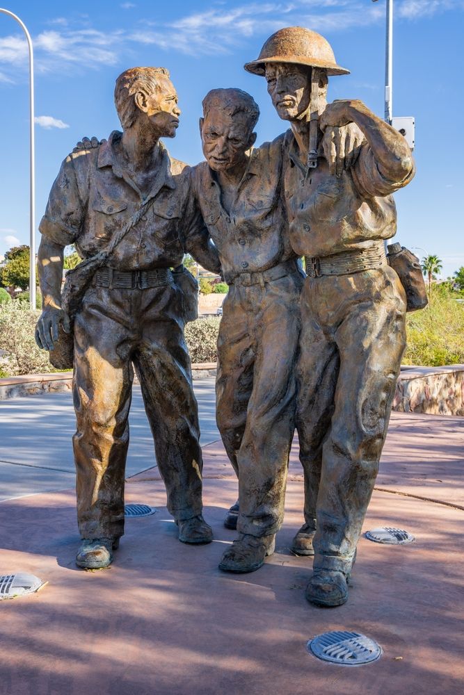 Statue of soldiers helping each other at Veterans Memorial Park
