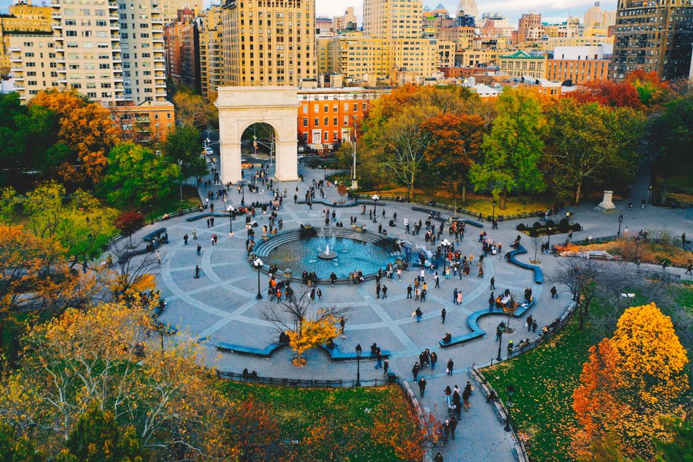 Visitors strolling around the Washington Square Park