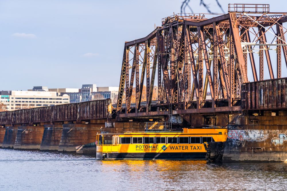 Water Taxi at the Potomac River sailing under a bridge