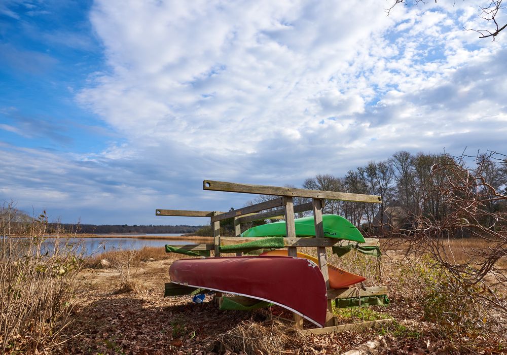 Canoes and Kayaks kept on the Westport River bank