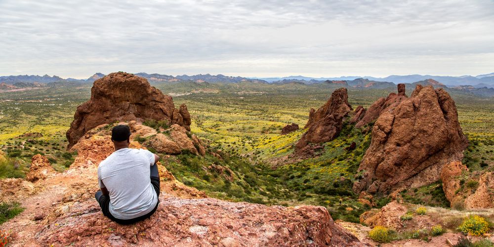 A man looking at the view from Treasure Loop Trail