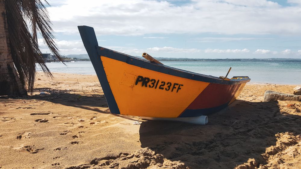 A boat on the sands of Crash Boat Beach