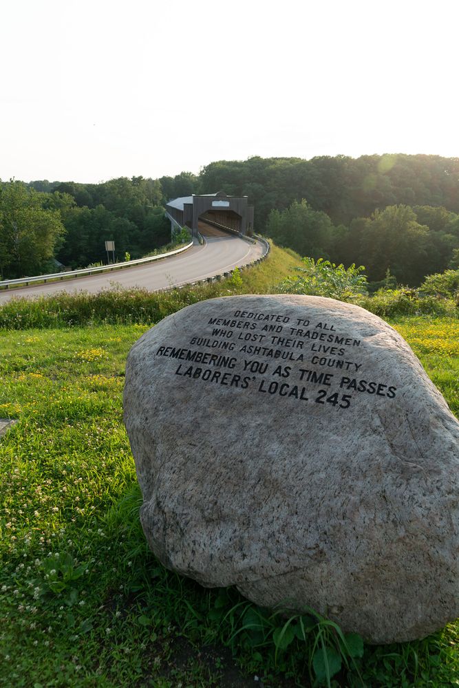 A boulder near gulf bridge entrance with a message dedicating it to the member/tradesmen who lost their lives building ashtabula county.