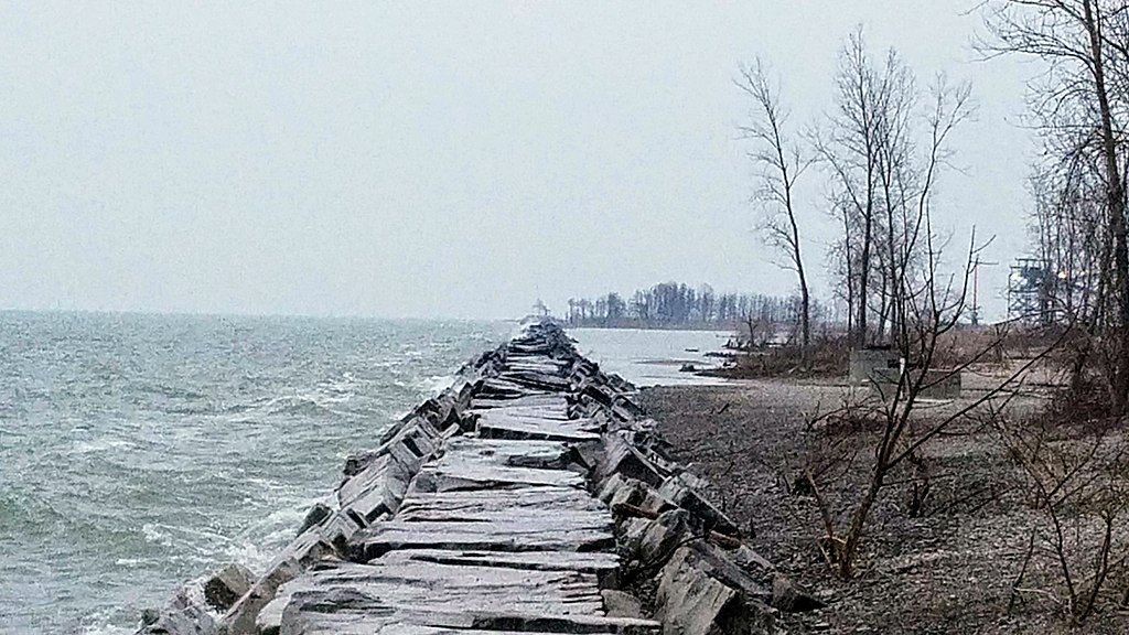 Body of water on the left, pathway on the middle, and trees on the right.