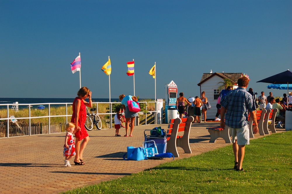 People walking along Bradley Beach boardwalk