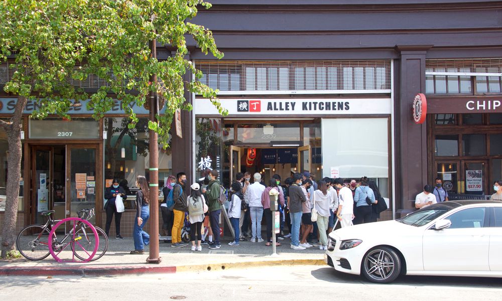 Students lined up in front of a sushi bar at Telegraph Avenue