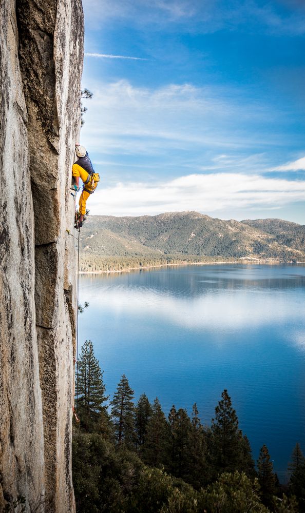 A man climbing on a rock in Lake Tahoe