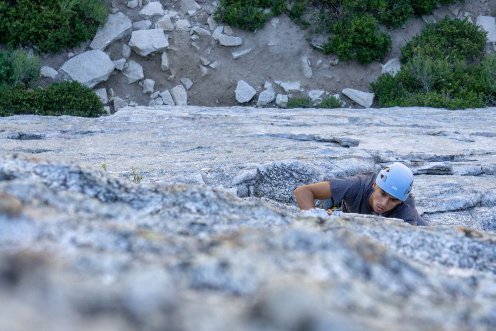 A man climbing on a rock in Lake Tahoe