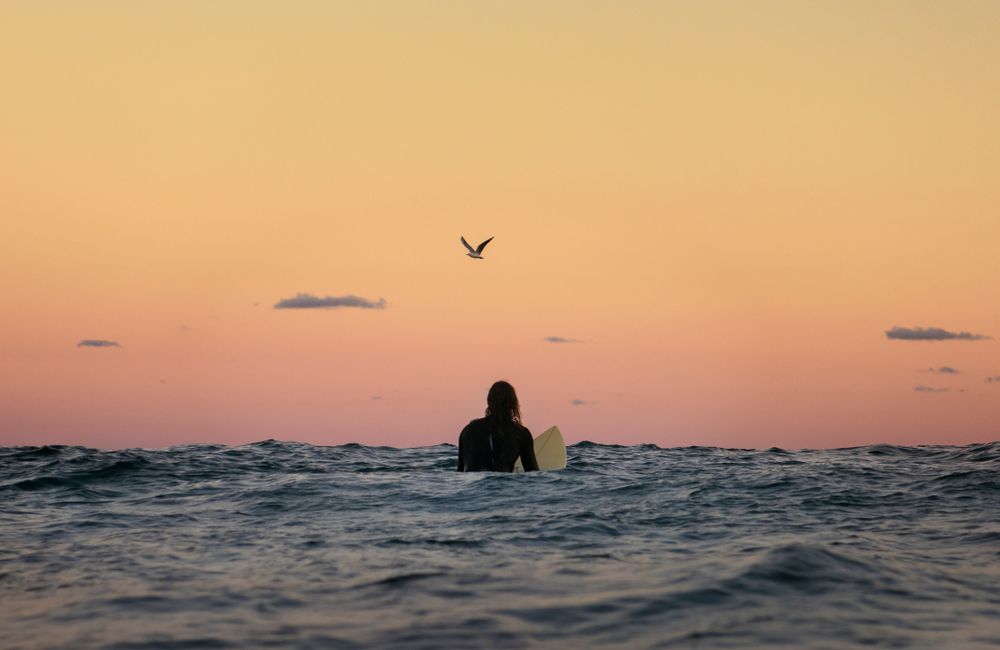Person admiring the sunset while swimming at bondi