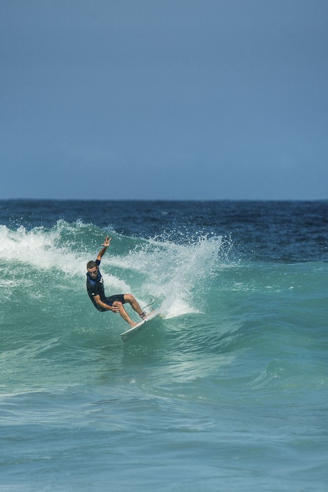 A person riding the waves in bondi beach