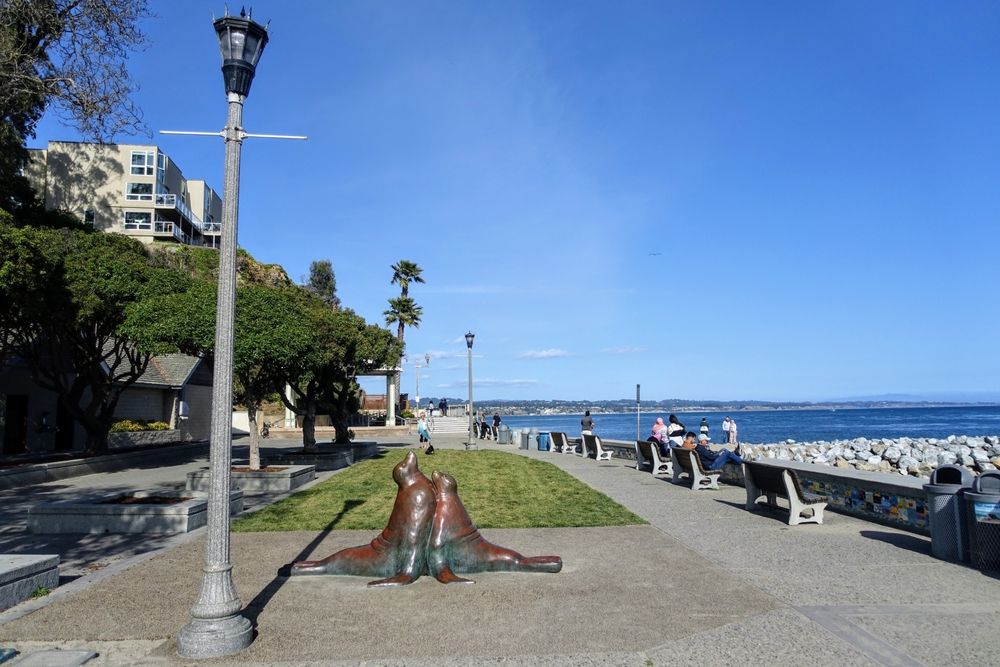 People walking along capitola's beachfront trail