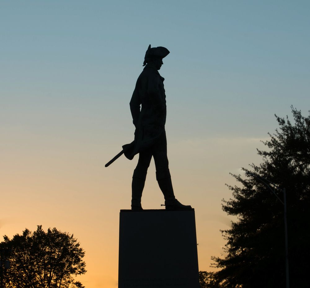 Silhouette of a patriot statue at Greensboro