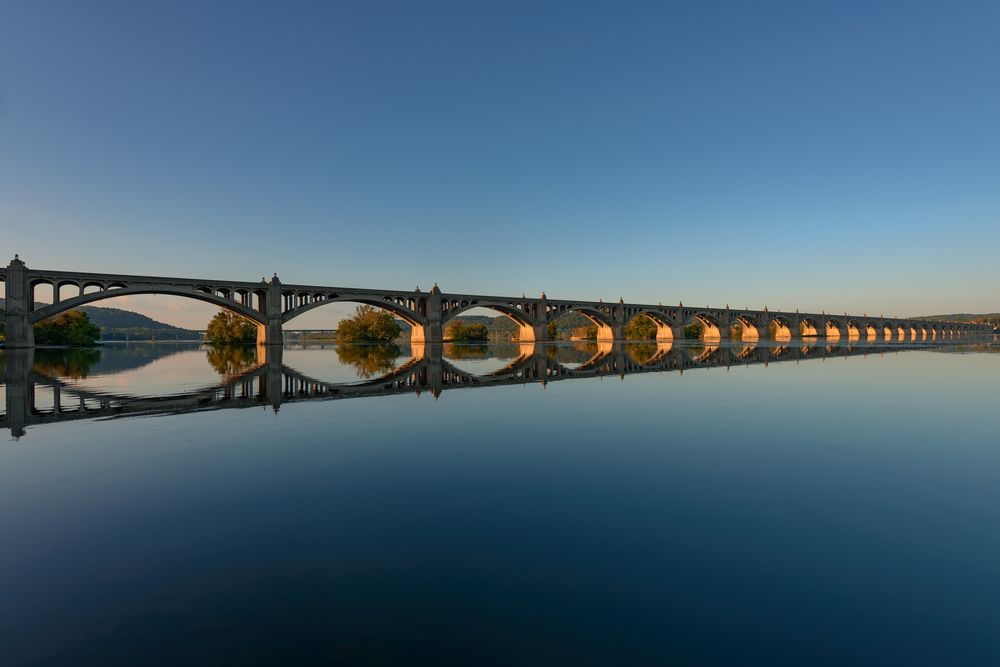 The Veterans Memorial Bridge reflecting on the river