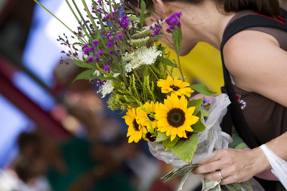 A woman purchasing flowers in North Market