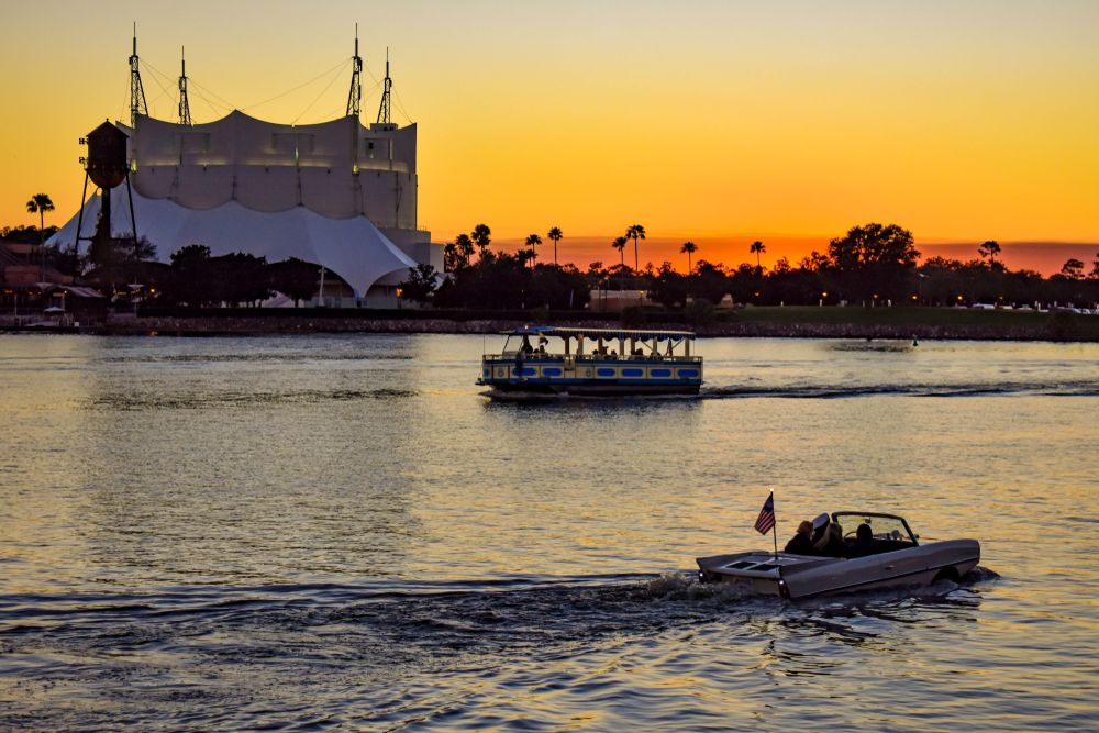 A tour boat and an amphicar near the Cirque du Soleil & Disney