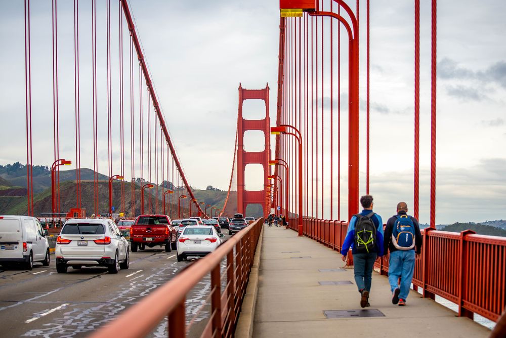 Cars and people along Golden Gate Bridge