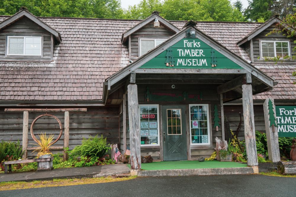 Exterior of the wooden house of forks timber museum during the day.