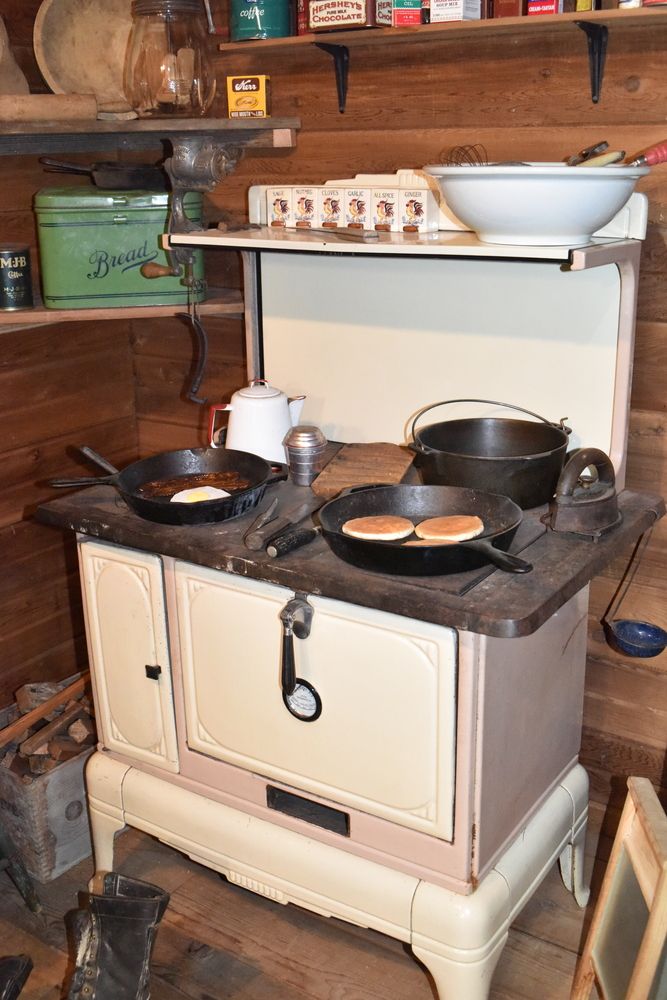 A vintage countertop with old cast iron pans inside the forks timber museum.