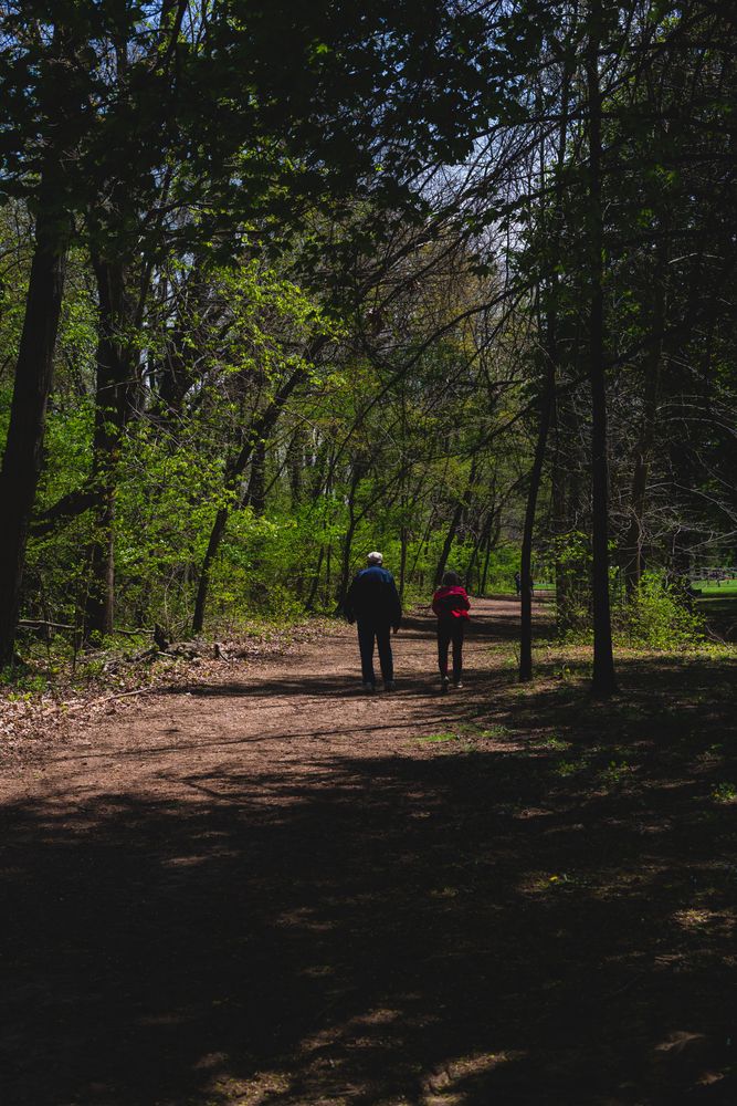 Two people walking along Ox Bow Park