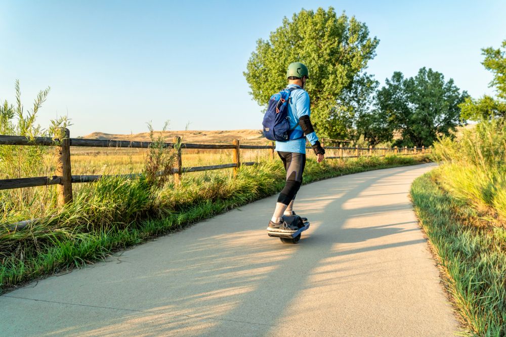 A man riding a skateboard at Poudre River Trail.