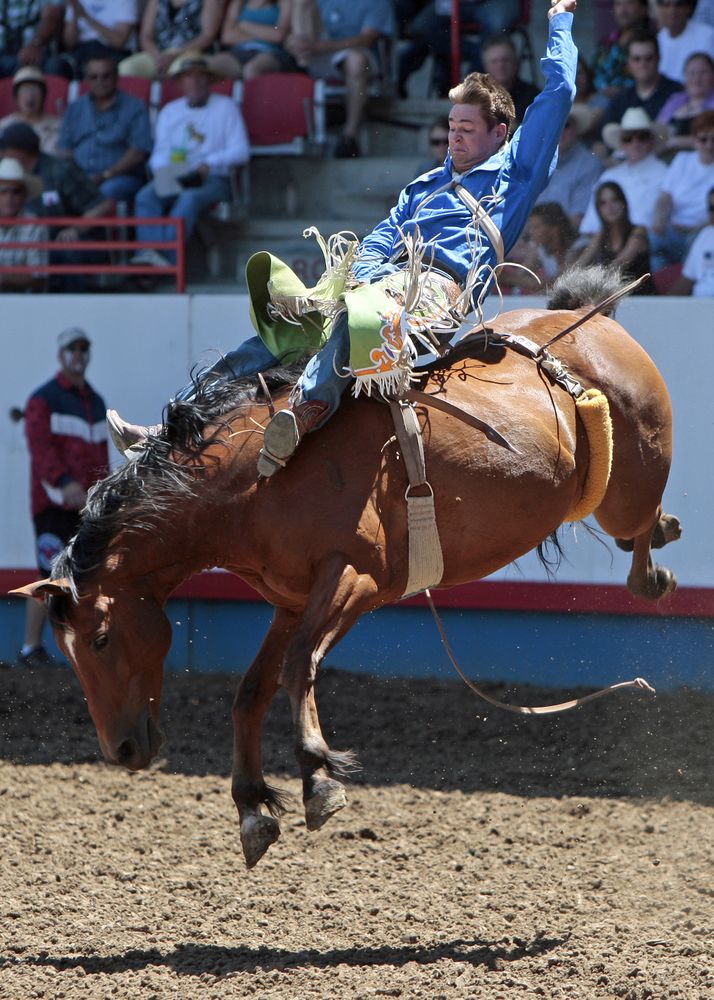 A man riding a horse at greeley Stampede.
