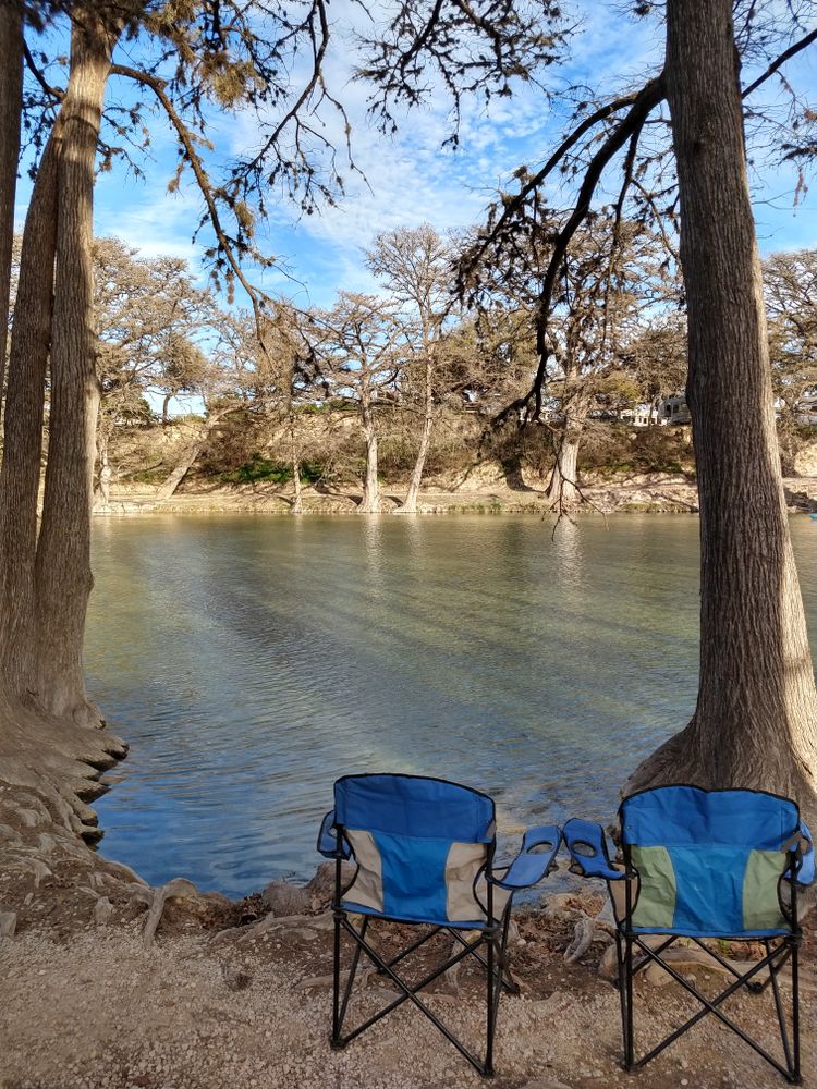 Two camping chairs near the waters of Frio River