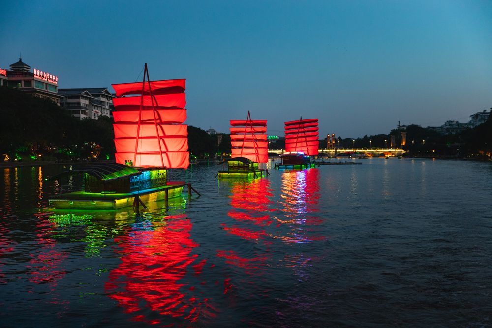 Brightly-lit tourist boats on Two Rivers and Four Lakes