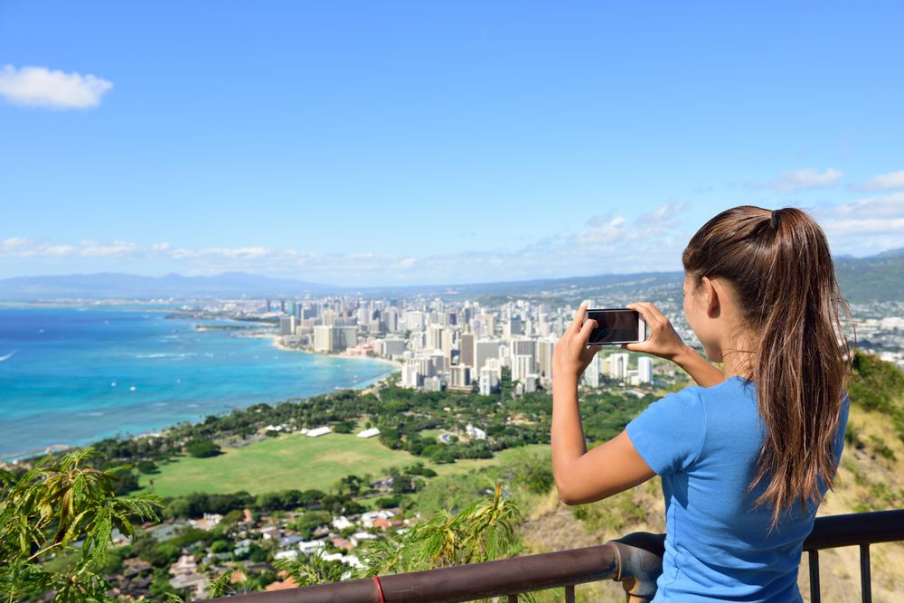 A person admiring the view from Diamond Head State Monument