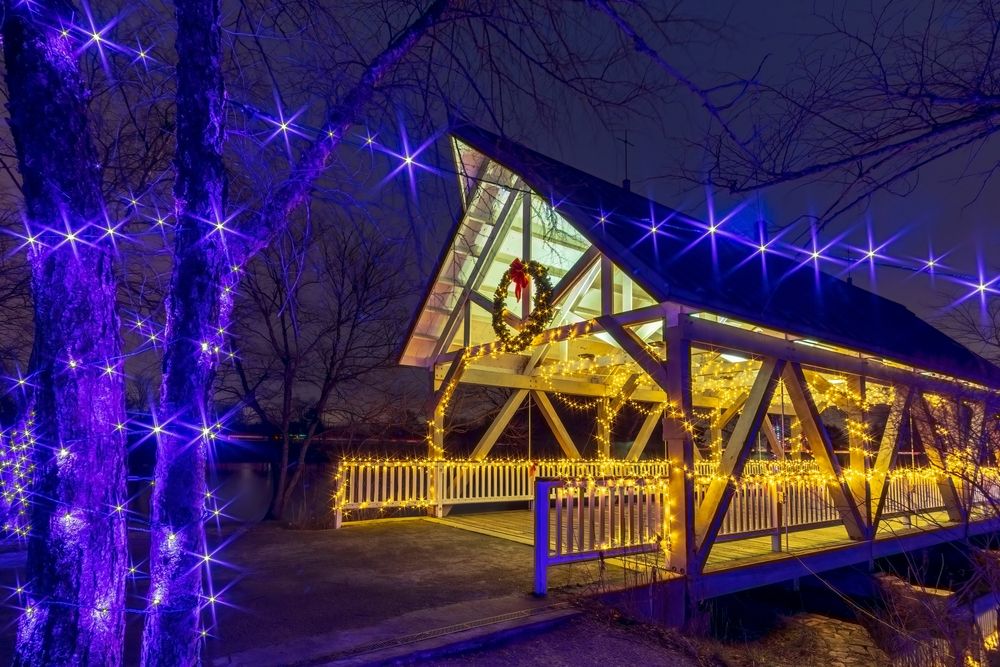 Holiday lights illuminating a covered bridge at Homestead Metro Park