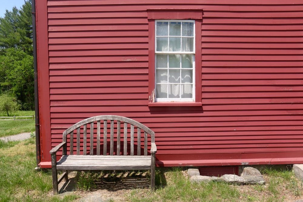 Wooden bench outside Fruitlands Museum's farmhouse