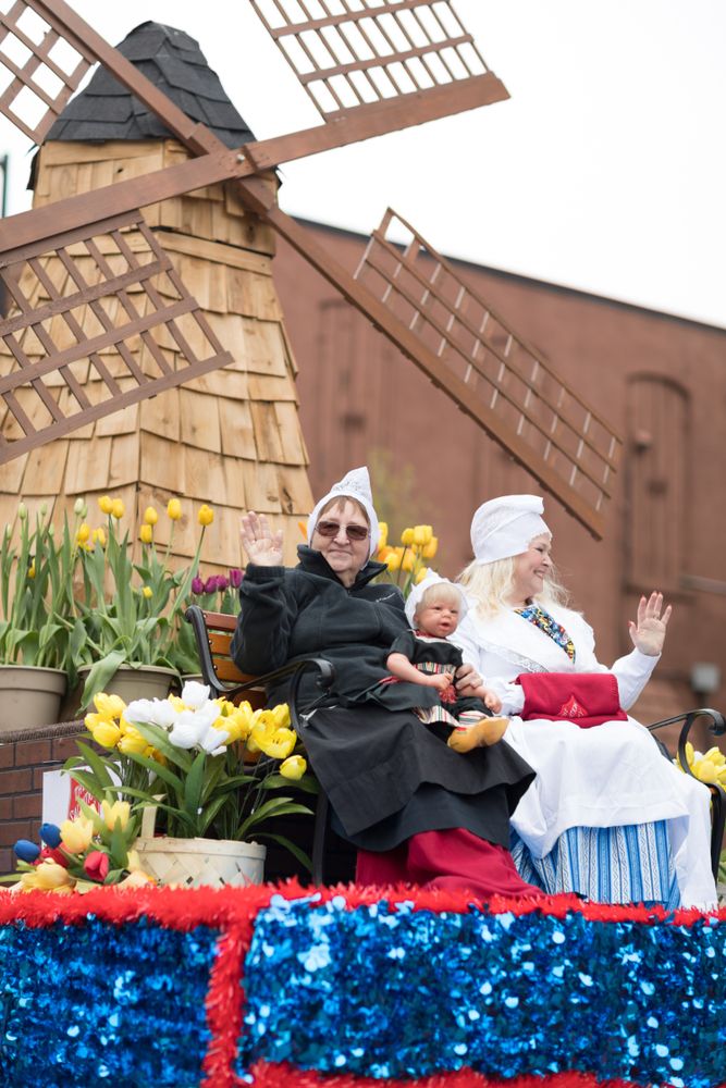Three people on a float for Tulip Time Festival