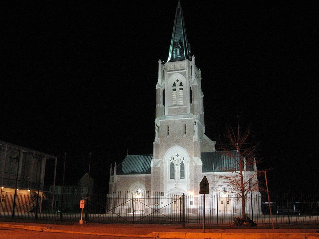 The well-lit building of St. Francis de Sales Cathedral at night.