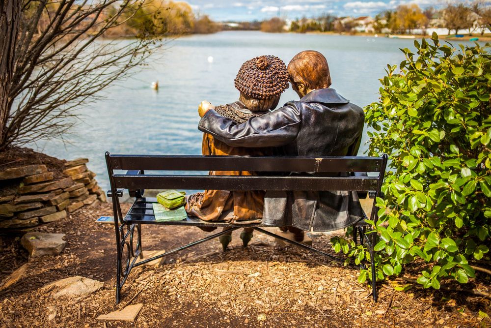 Couple sitting on a bench sculpture at Grounds For Sculpture