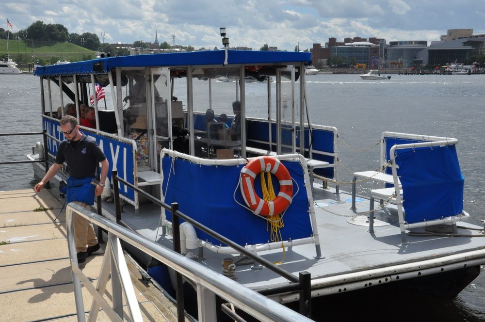 A person climbing out a Baltimore Water Taxi