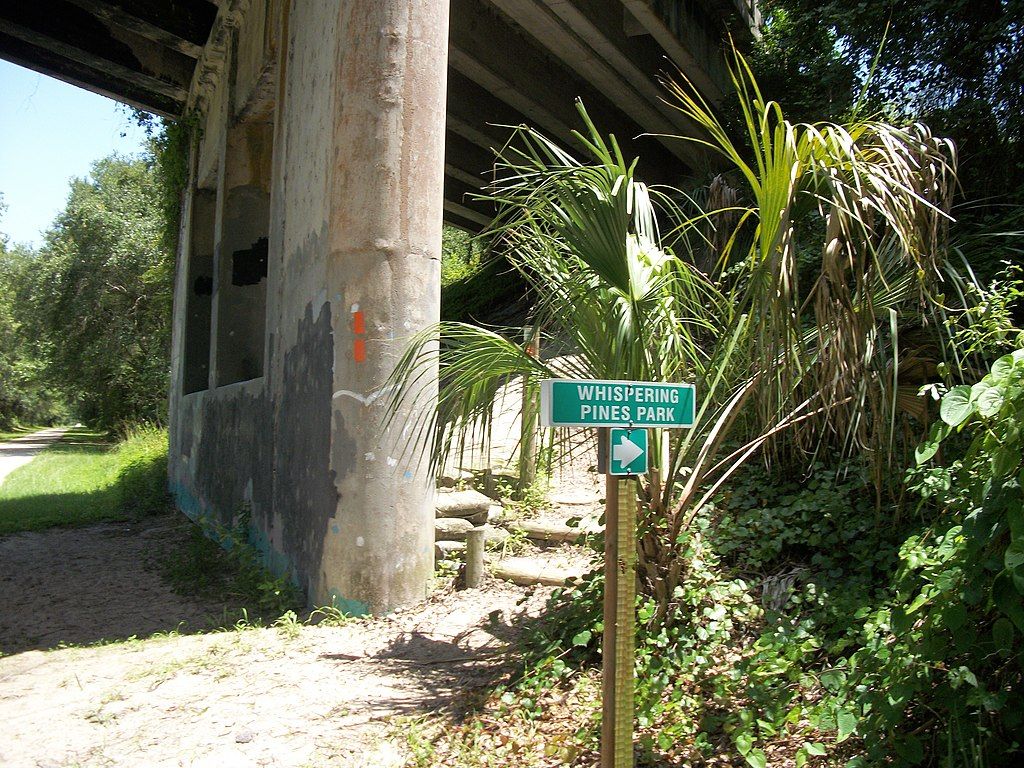 Sign direction pointing to the Whispering Pines Park entrance