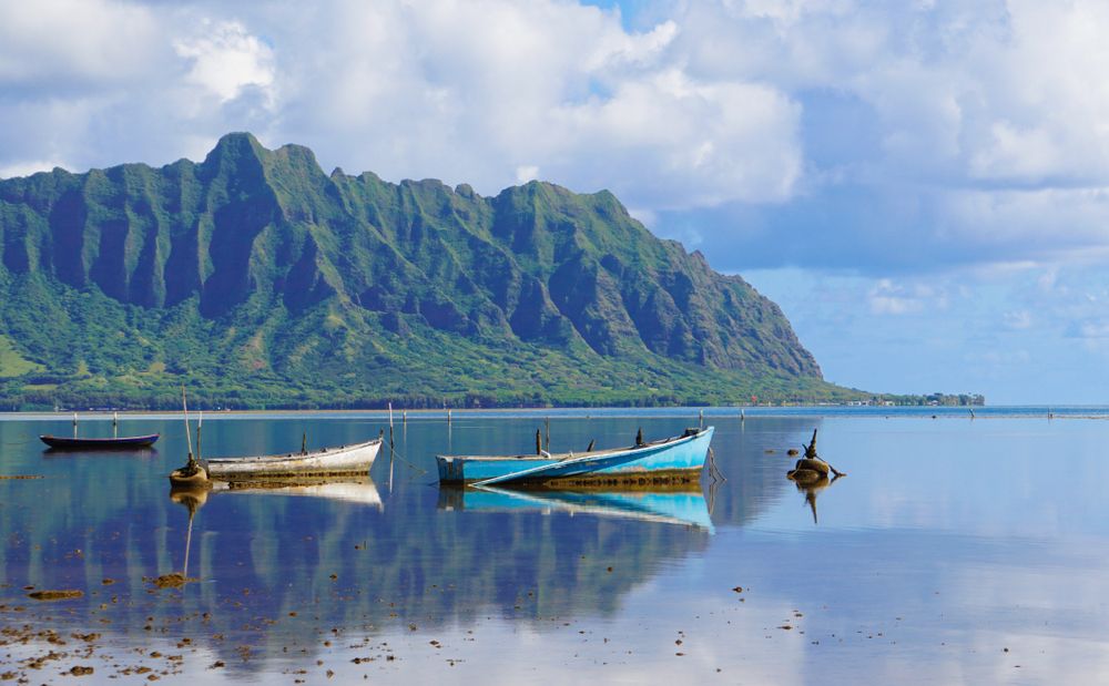 Boats reflecting on the still waters of Kāneʻohe Bay