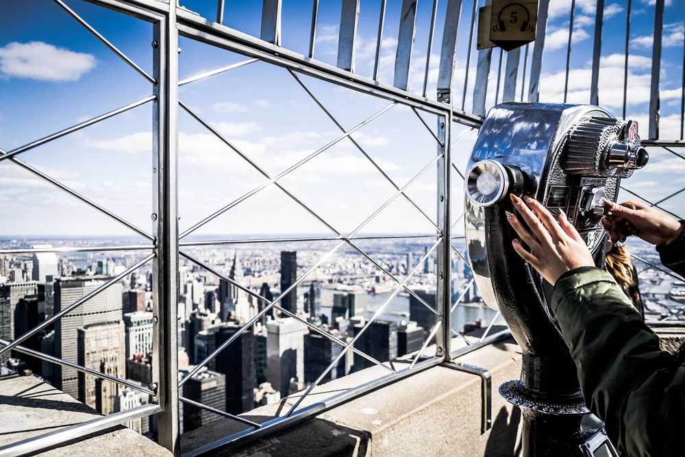 A person using the telescope in Empire State Building's top floor