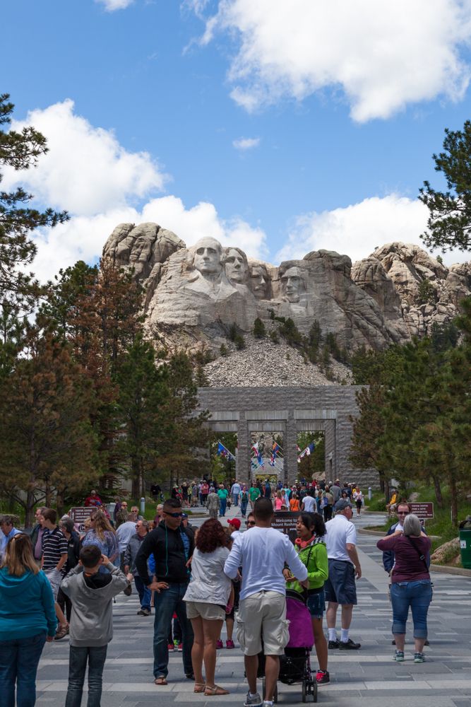 People walking towards Mount Rushmore National Memorial