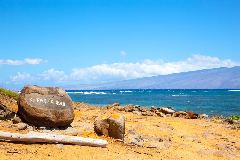 A rock with the words "Shipwreck Beach"