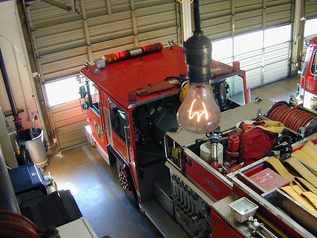A fire truck under the Centennial Light Bulb