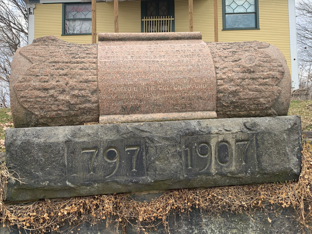 Scroll-shaped monument in front of David Mead's House