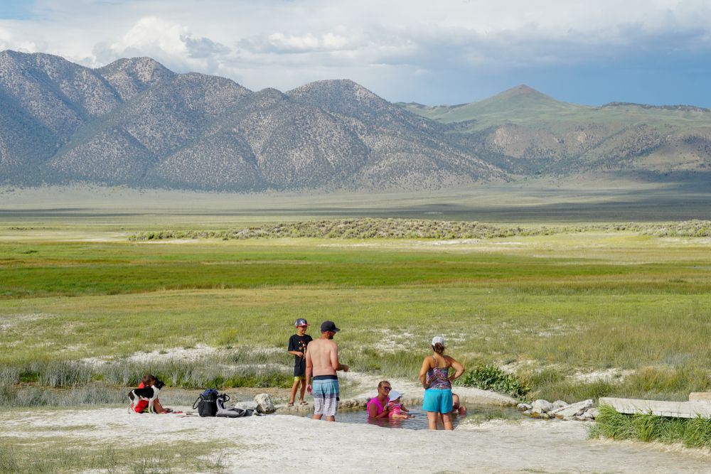 People enjoying the water of Wild Willy’s Hot Springs