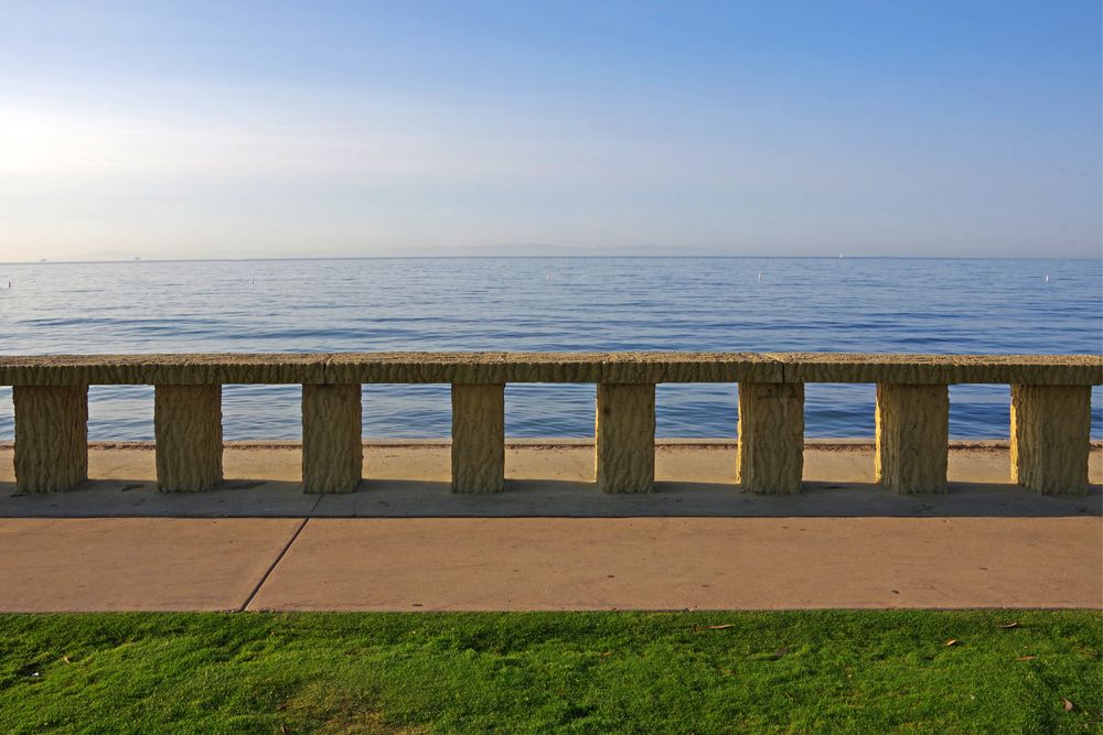 Stone rail and the Butterfly Beach at the back