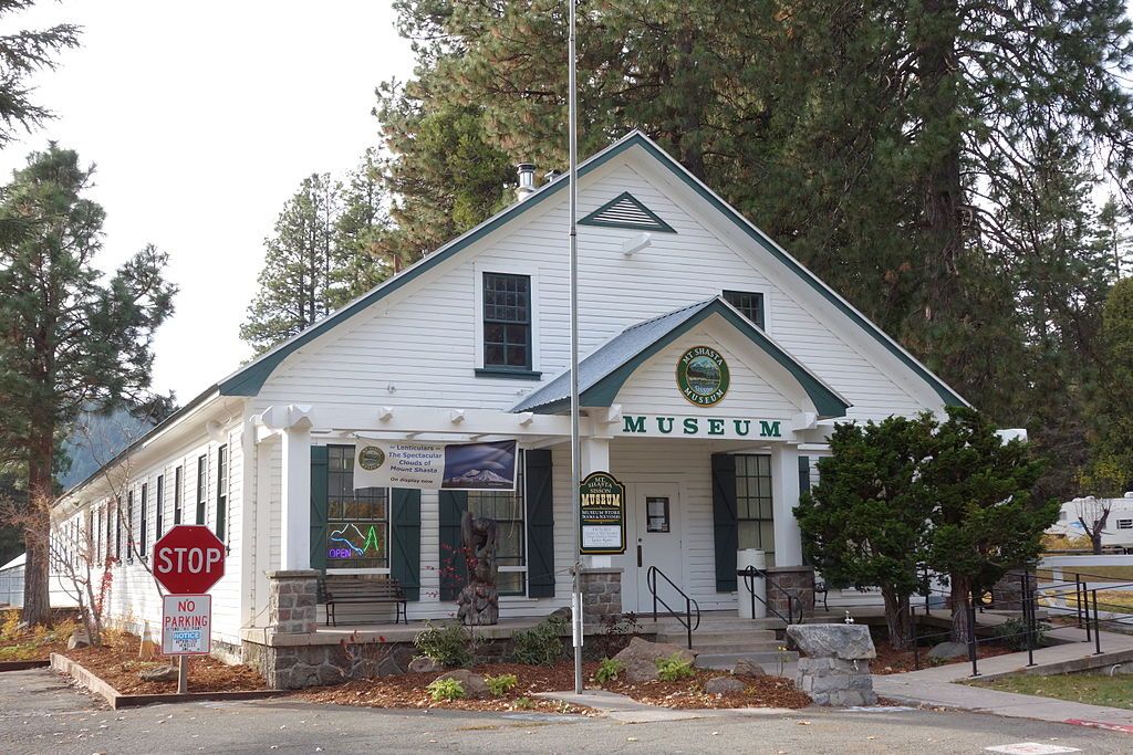 Exterior of the Mt. Shasta Sission museum with a stop sign on the left side.