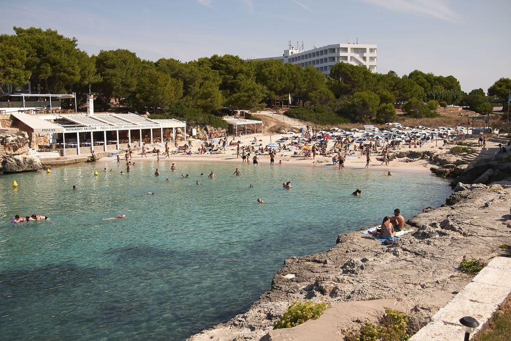 People swimming at Cala Blanca Beach