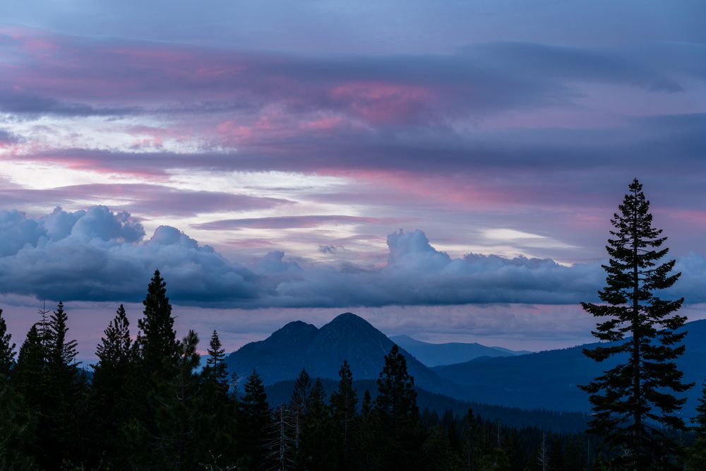 Blue, purple and pink sunset with the silhouette of black butte.
