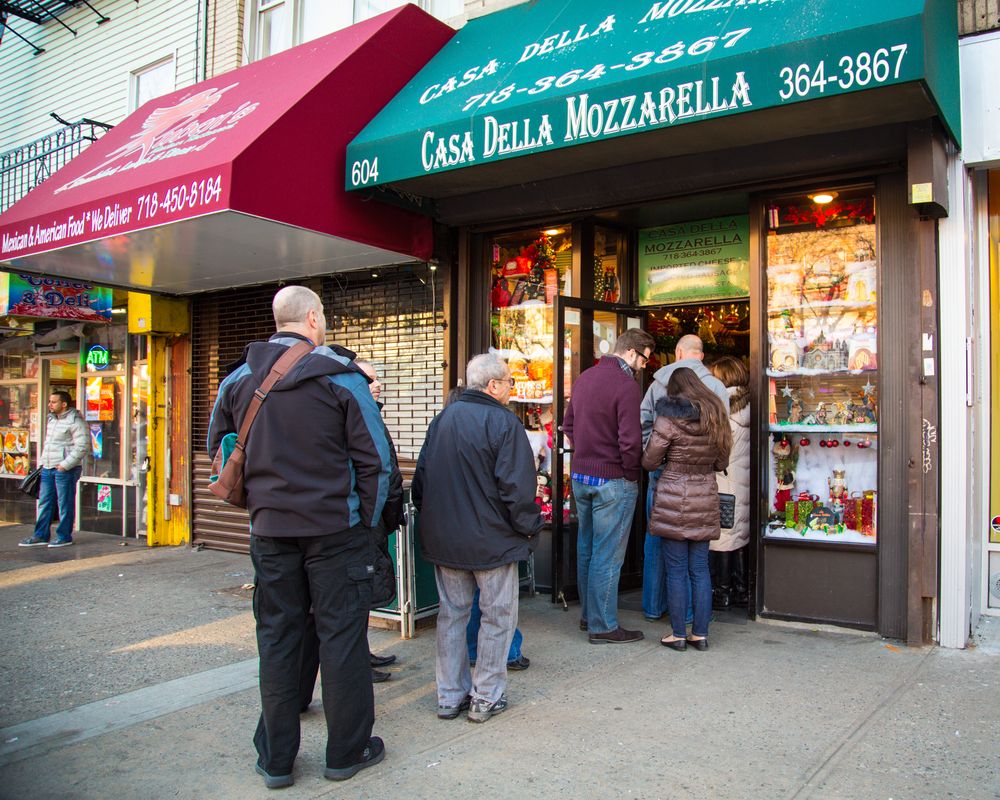 People lined up outside a shop at Bronx Little Italy