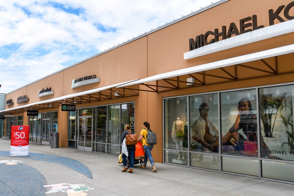 People walking along Seattle Premium Outlets