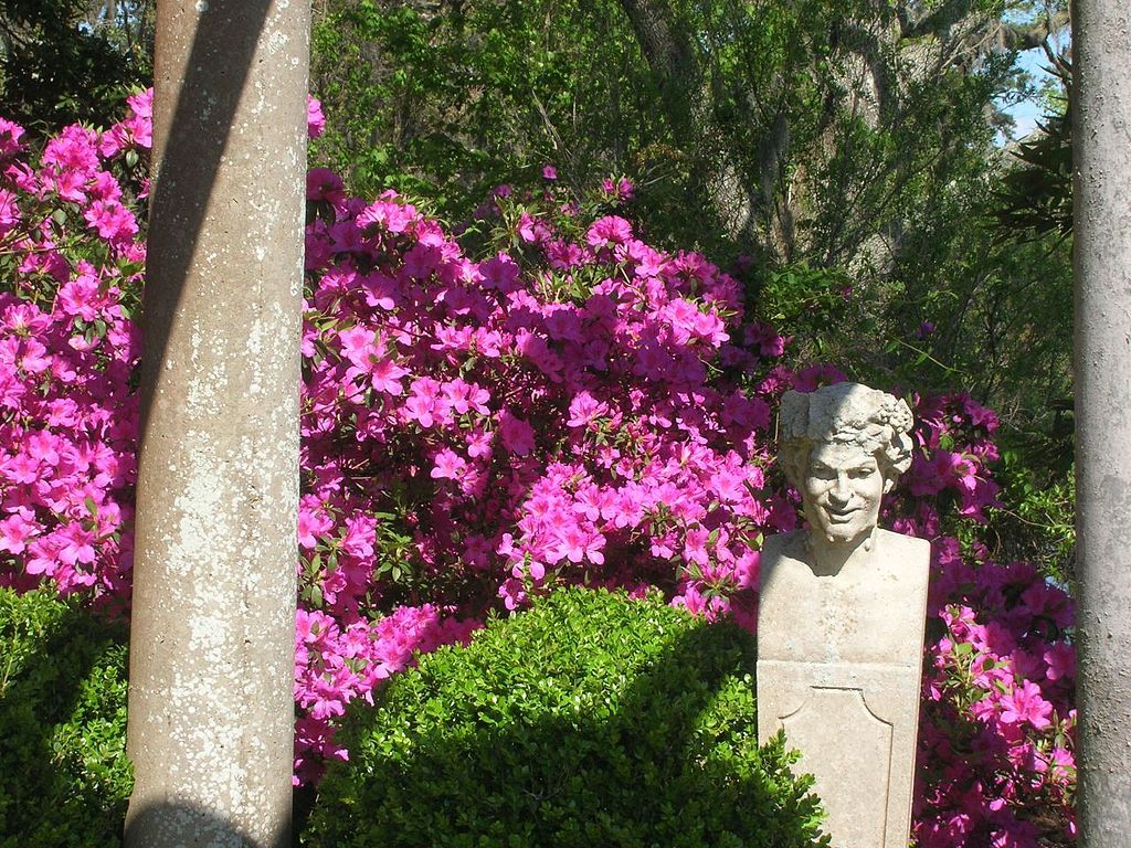 Flowers behind a statue at Airlie Gardens