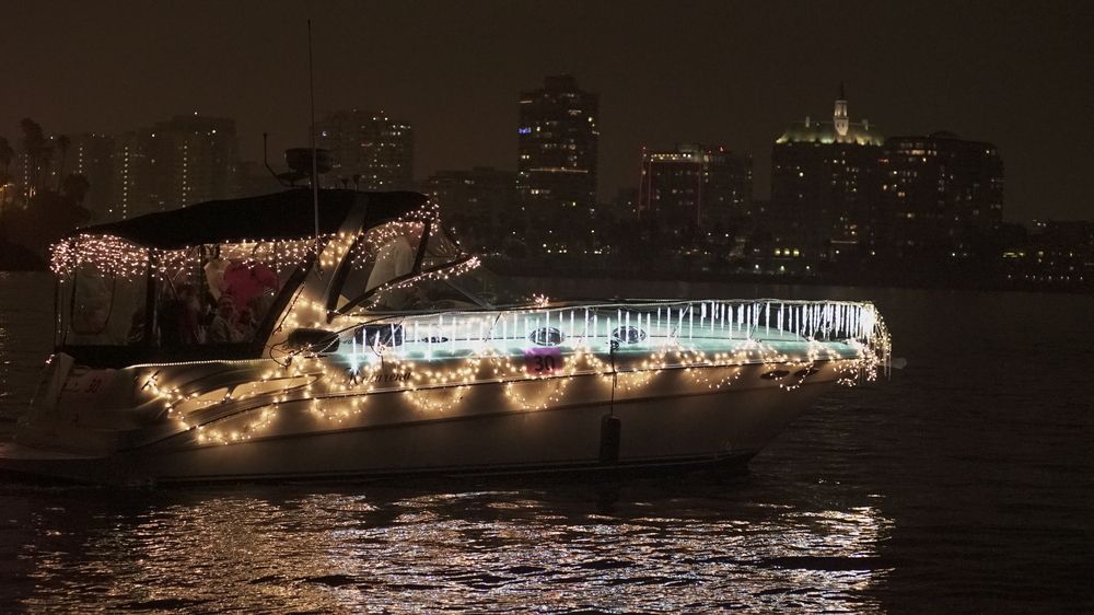 A boat decorated with holiday lights during the Christmas Boat Parade